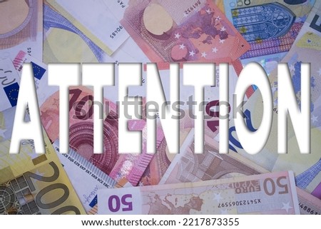 Attention word with money. Paper currency background with different banknotes.