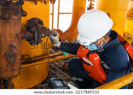 Inspectors inspect pipes severe corrosion the petrochemical industry oil and gas with ultrasonic instruments. Royalty-Free Stock Photo #2217889533