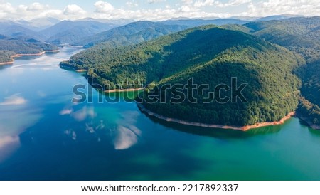 Aerial photography of Vidraru lake, in Romania. Photography was shot from a drone from above  the dam at Vidraru lake with the camera at horizontal position for a landscape still.