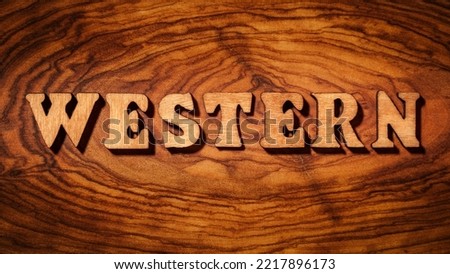 Western - Single word on wood close up Royalty-Free Stock Photo #2217896173