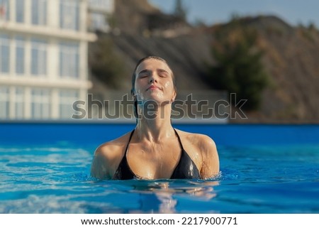 Beautiful girl in bikini holiday in the swimming pool