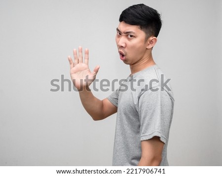 Asian man grey shirt feels angry turn around say no show hand hold isolated Royalty-Free Stock Photo #2217906741