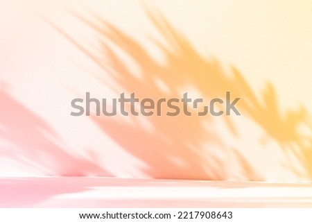 Abstract gradient orange studio background for product presentation. Empty room with shadows of window and flowers and palm leaves . 3d room with copy space. Summer concert. Blurred backdrop.