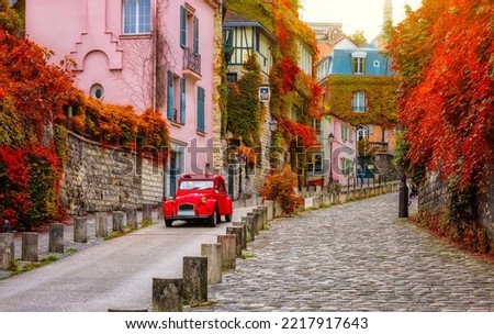 Cozy street in quarter Montmartre in Paris, France. Architecture and landmarks of Paris. Postcard of Paris Royalty-Free Stock Photo #2217917643