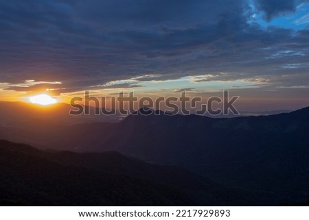 Sun rising over the clouds, in the hills of the Serra do Mar. Sao Paulo, Brazil