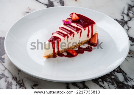 Cheesecake with strawberries on plate, wooden table background, strawberry cheesecake Royalty-Free Stock Photo #2217935813
