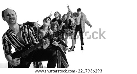Group of stylish expressive people, man and woman, rock music performers posing over white background. Generation of 50s. Concept of music, rock and roll, lifestyle, fashion. Copy space for ad. Flyer