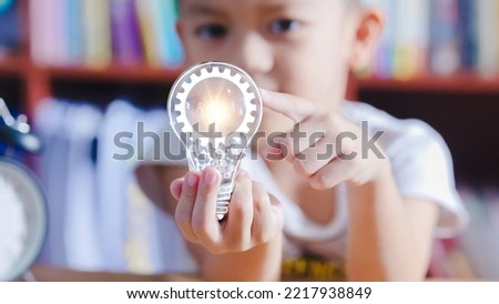 Education concept,Little boy holding light bulb, LMS - Learning Management System web icon for lesson and online education, course, application, study, e learning.