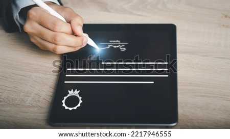 Paperless workplace and Digital Signature or e-signature concept. Businessman using stylus e-pen write signing on certificate in tablet certificate file acceptance work on network connection.