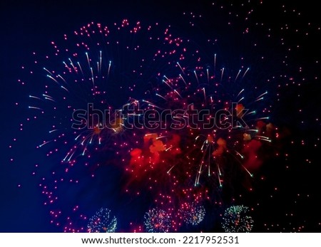 Amazing holiday colorful fireworks display on celebration, showing. Festive beauty firework with sparks, colored stars and bright nebula on black night sky universe, comets. Copy text space