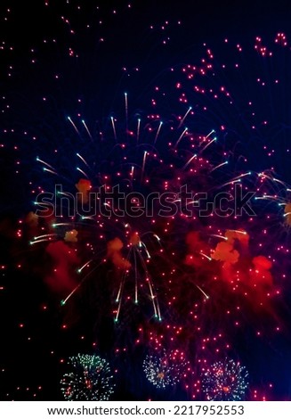 Amazing holiday colorful fireworks display on celebration, showing. Festive concept. Fireworks with sparks, colored stars and bright nebula on black night sky universe, comets. Copy text space