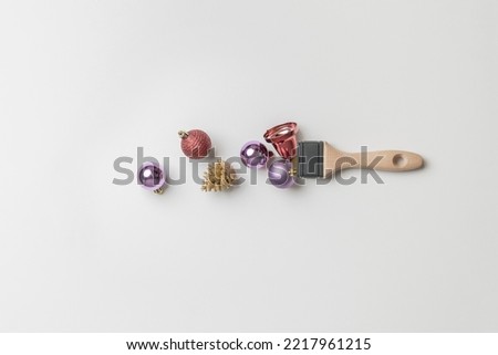 creative christmas concept with brush and decorative balls flat lay