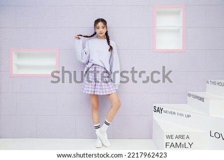 Fashion portrait of a young Asian woman in sporty fashion