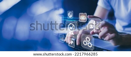 Businessman working on laptops with signs of the top service Quality control certification, ISO, checked guarantees of the standard of company product. Concept on virtual screen.