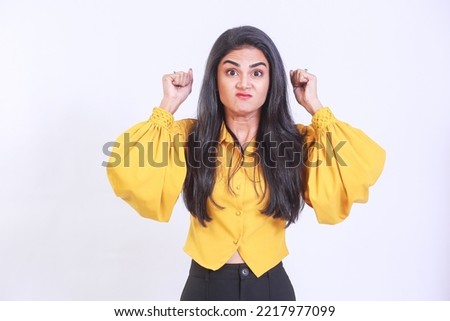 Young woman with long hair over isolated white wall frustrated by a bad situation wearing trendy yellow top