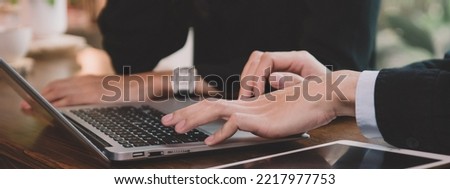 Close-up of employees using laptop to present strategies to supervisor, businesswomen discussing business plans with partners at modern co-working spaces, business meetings and briefings, banner size