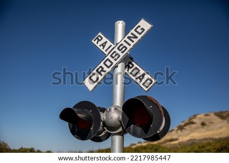 railroad crossing sign on blue sky