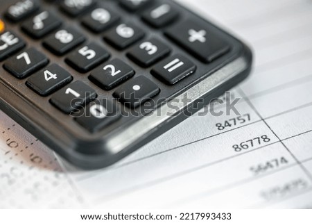 Calculator and numbers on paper closeup, finance concept.