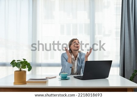 Young frustrated business woman office worker trying to concentrate for her work while she sitting in the company office with old laptop computer and slow internet connection. Royalty-Free Stock Photo #2218018693