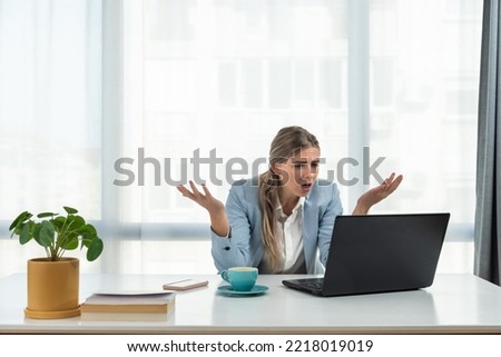 Young frustrated business woman office worker trying to concentrate for her work while she sitting in the company office with old laptop computer and slow internet connection. Royalty-Free Stock Photo #2218019019