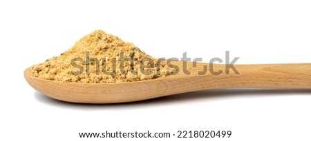 Soup powder in wooden spoon isolated. Instant powdered broth, bouillon concentrate with herbs and spices on white background side view