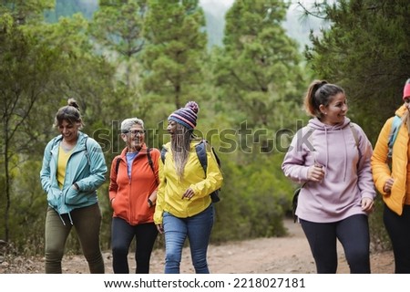 Group of multiethnic women having fun together during trekking day at mountain forest Royalty-Free Stock Photo #2218027181
