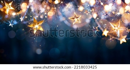 Christmas Lights - Stars String Hanging At Fir Branches In Abstract Defocused Background Royalty-Free Stock Photo #2218033425