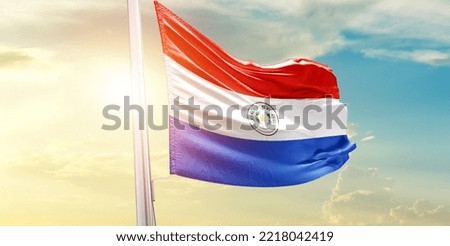 Paraguay national flag waving in beautiful clouds.