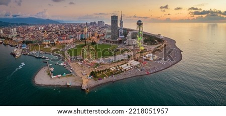 Panoramic aerial view of Batumi, Georgia. The Ferris Wheel and the Alphabet Tower are in the foreground. Royalty-Free Stock Photo #2218051957
