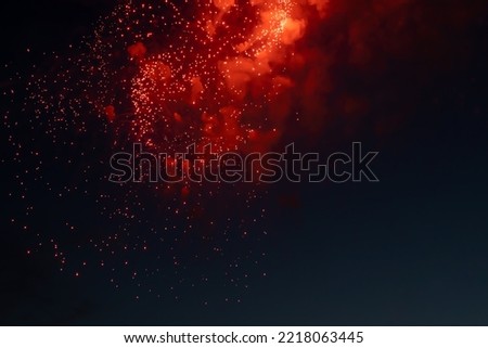 Fireworks lights on a background of red clouds. Background picture. Soft focus.