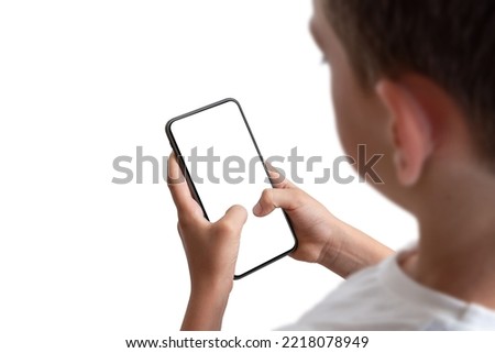 Boy holding smart phone with isolated display and background Royalty-Free Stock Photo #2218078949