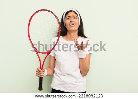 young pretty hispanic woman looking desperate, frustrated and stressed. tennis concept