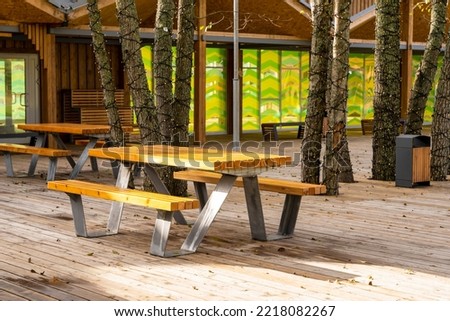 empty tables and chairs on the terrace of an outdoor outdoor cafe