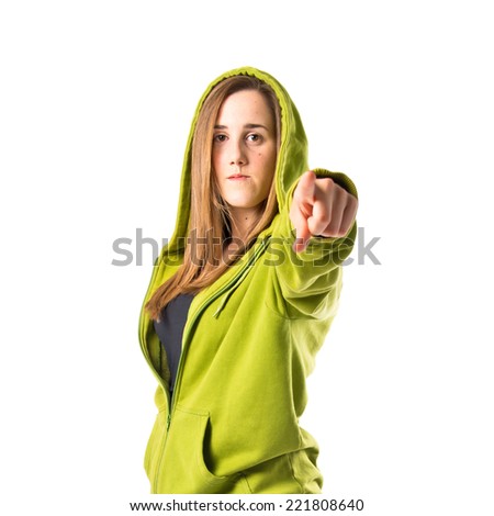 Young pretty woman pointing over white background 