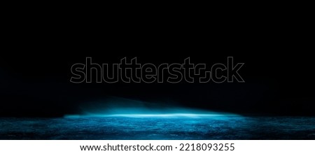 Abstract image of dark room concrete floor. Black room or stage background for product placement.Panoramic view of the abstract fog. White cloudiness, mist or smog moves on black background. 