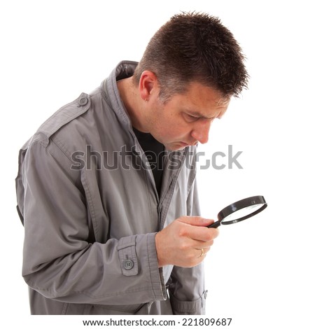 Man with raincoat is looking with magnifying glass over white background