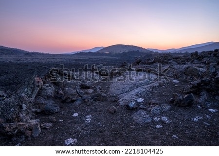 USA, Idaho, Craters of the Moon National Monument and Reserve. Lava field with dwarf buckwheat at sunset