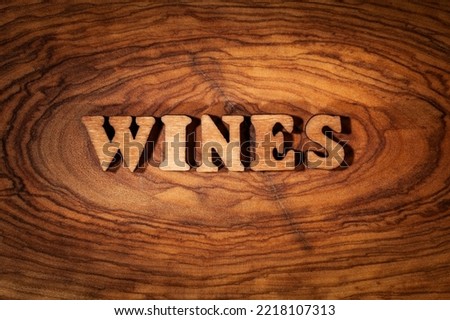 Wines - Single word on wood close up Royalty-Free Stock Photo #2218107313