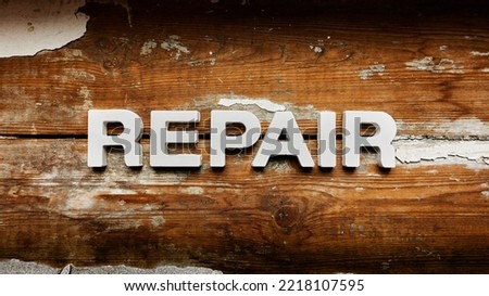 Repair - Single word on old worn wooden planks Royalty-Free Stock Photo #2218107595