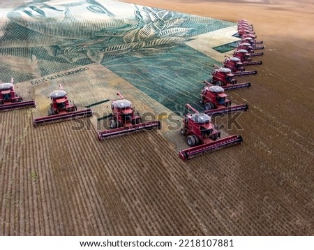 Mass soybean harvesting at a farm in Mato Grosso state,Brazil. Concept brazilian real bank note wirh agribusiness. and commodities. Royalty-Free Stock Photo #2218107881
