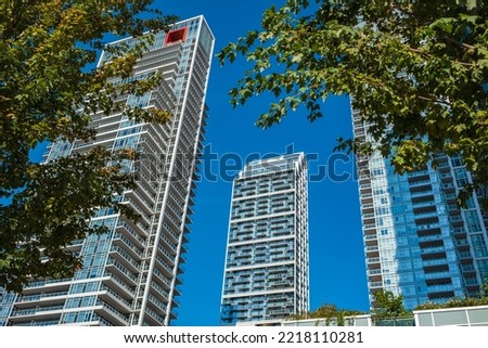 New modern high rise apartment complex in Vancouver BC. Bottom up view on new modern residential buildings. Skyscrapers from a low angle view in modern city. Nobody, street photo