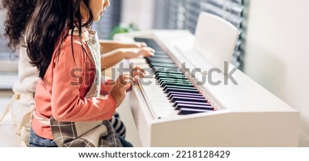 Asian young musician girl kid having fun activities play piano music lesson in music education at home