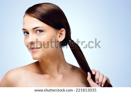 Portrait of a happy beautiful girl on blue background
