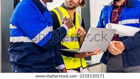 Professional of team architect industrial engineer cargo foreman in helmet working new construction project architectural plan with blueprint and construction tool at the building construction site