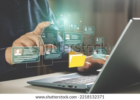 HR concepts and personal file storage, personal information management, checklists. Businessmen working in HR checklists of employees or job applicants through a virtual screen from tablet computer. Royalty-Free Stock Photo #2218132371