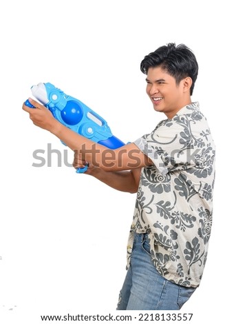 Portrait handsome man in floral shirt and jeans holding water bowl, smiling with happy on white background, Happy friends with Songkran festival, Thailand culture Thai's new year day Royalty-Free Stock Photo #2218133557