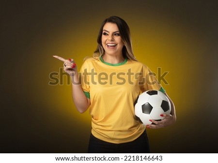 Brazilian fan. Brazilian woman fan celebrating in soccer or soccer match on yellow background. Brazil colors