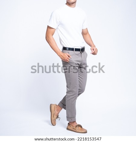 Man wearing white basic t shirt and grey chino pants catalogue Royalty-Free Stock Photo #2218153547