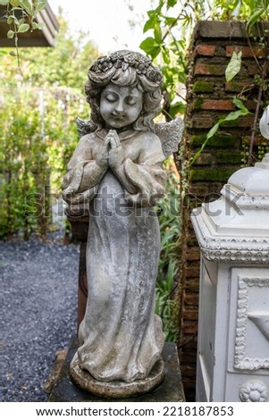 sculpture of girl decorated in the English garden