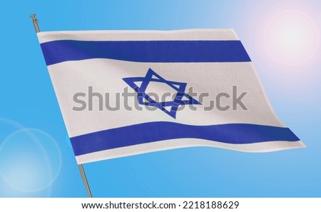 Waving national flag of Israel on blue sky